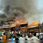 Boats anchored on the banks of river catch fire
