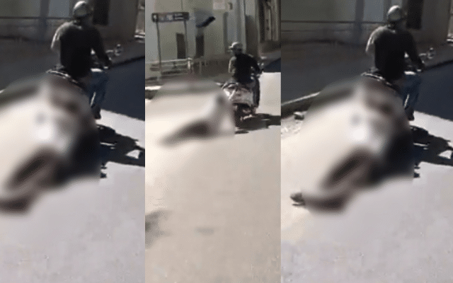 A video of a man being dragged for a kilometre behind a scooter has gone viral.