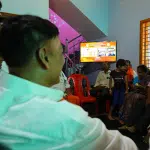 BJP candidate Rajesh Naik watches Pm Modi's speech along with party workers