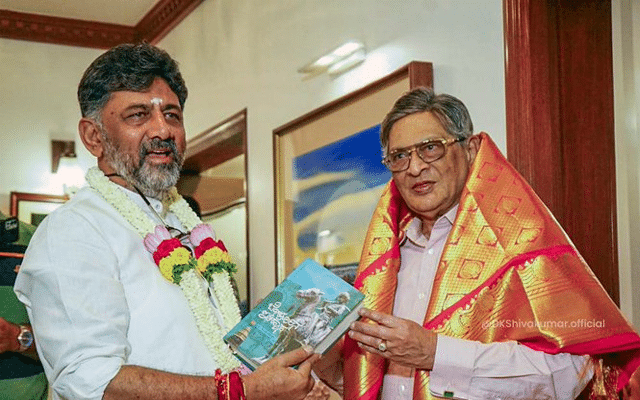 DK met SM Krishna and gifted him a book. Shivakumar