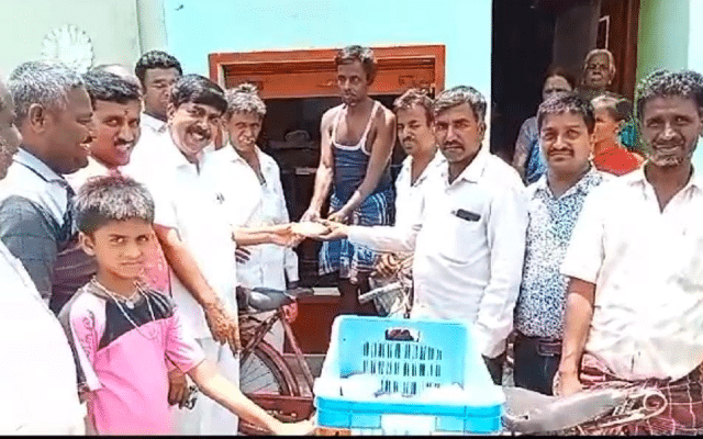 On taking oath as Chief Minister, party workers distribute sweets door-to-door